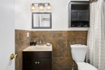 Elegant, second floor full-bathroom, styled w/ a dark brown & crispy white shade